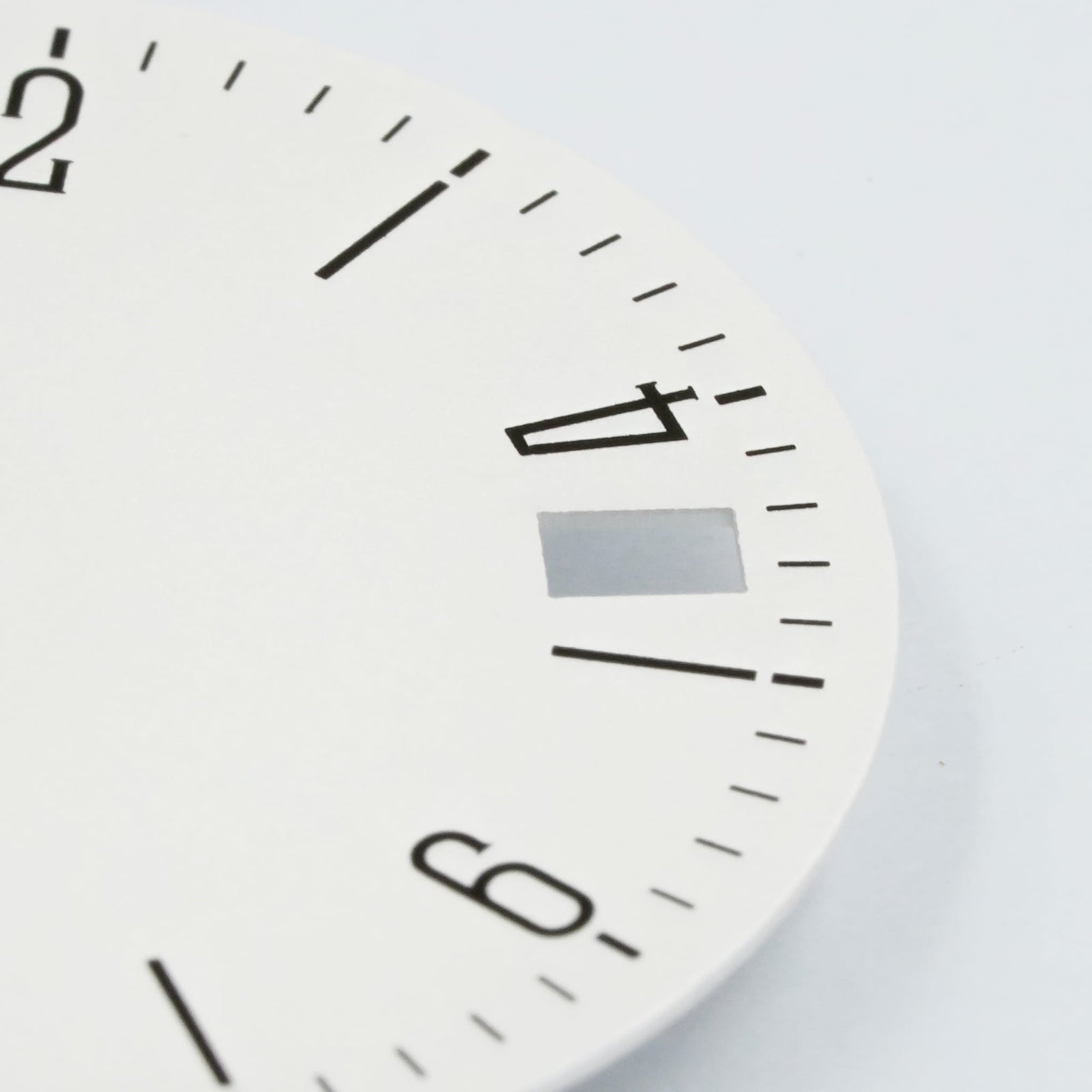 Bauhaus date dial macro close-up showing 4 o'clock date window and flat-printed minute track — Lucius Atelier