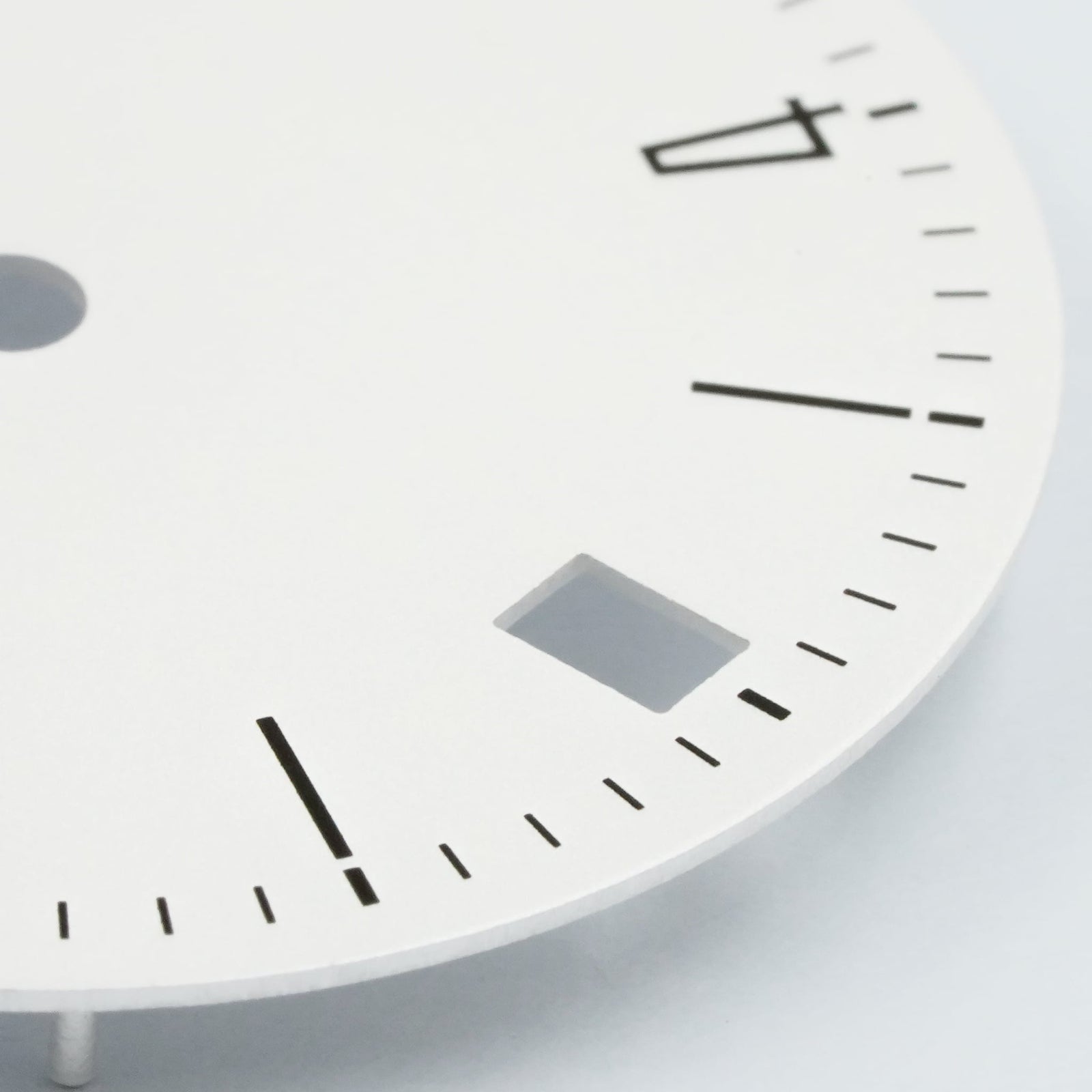 Bauhaus date dial at 6H macro close-up showing 6 o'clock date cutout and flat-printed minute track — Lucius Atelier