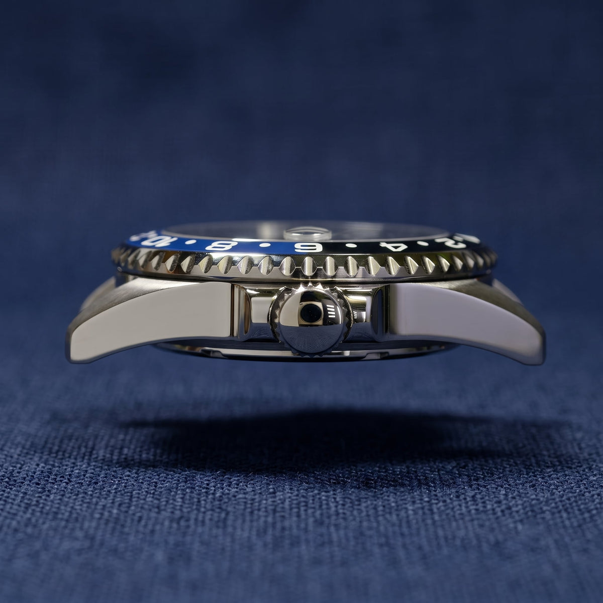 SKX013 GMT 38 Batman Ultra Thin — side profile on navy fabric showing the slim case and the black and blue insert edge