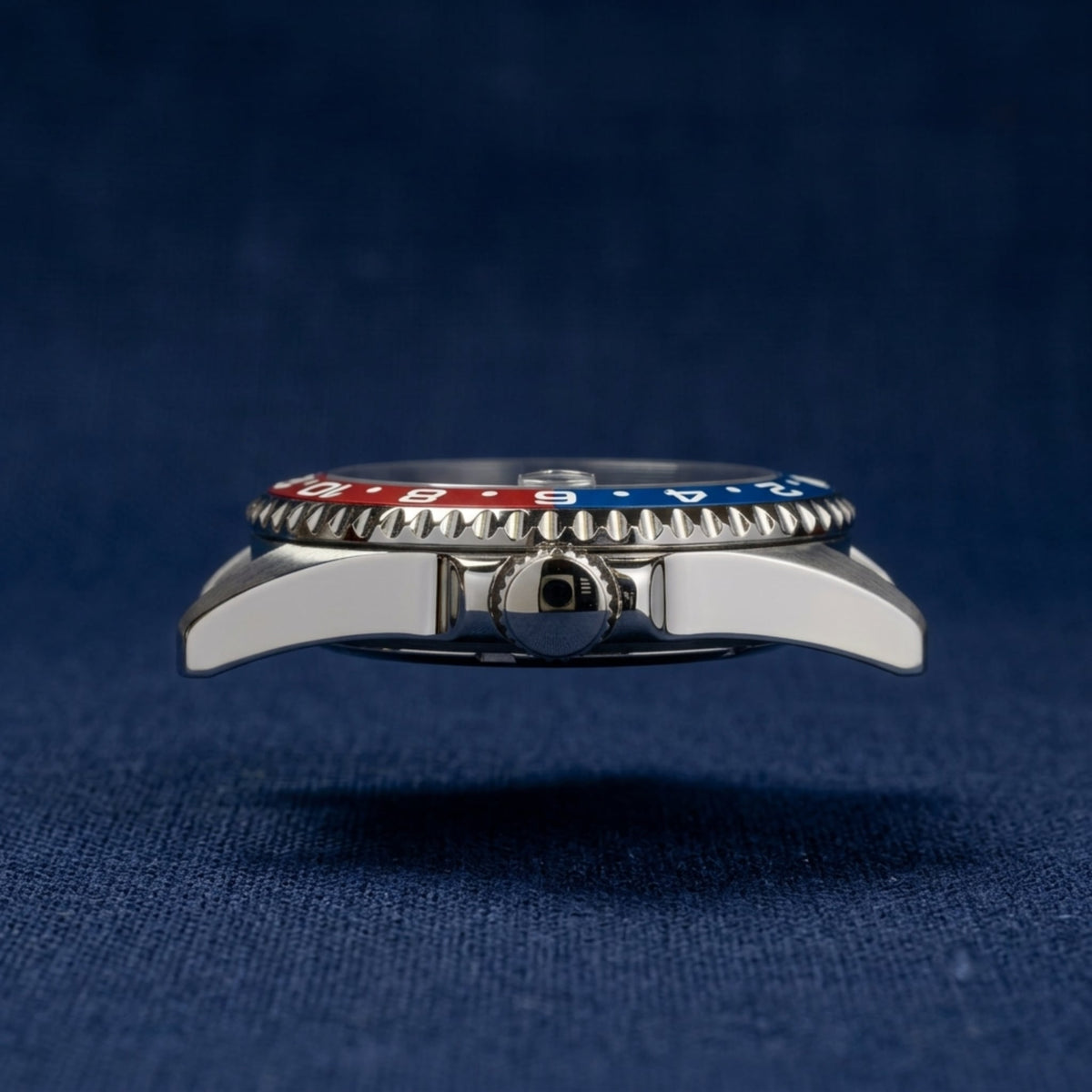 SKX013 GMT 38 Pepsi Ultra Thin — side profile on navy fabric showing the slim case and the blue and red insert edge