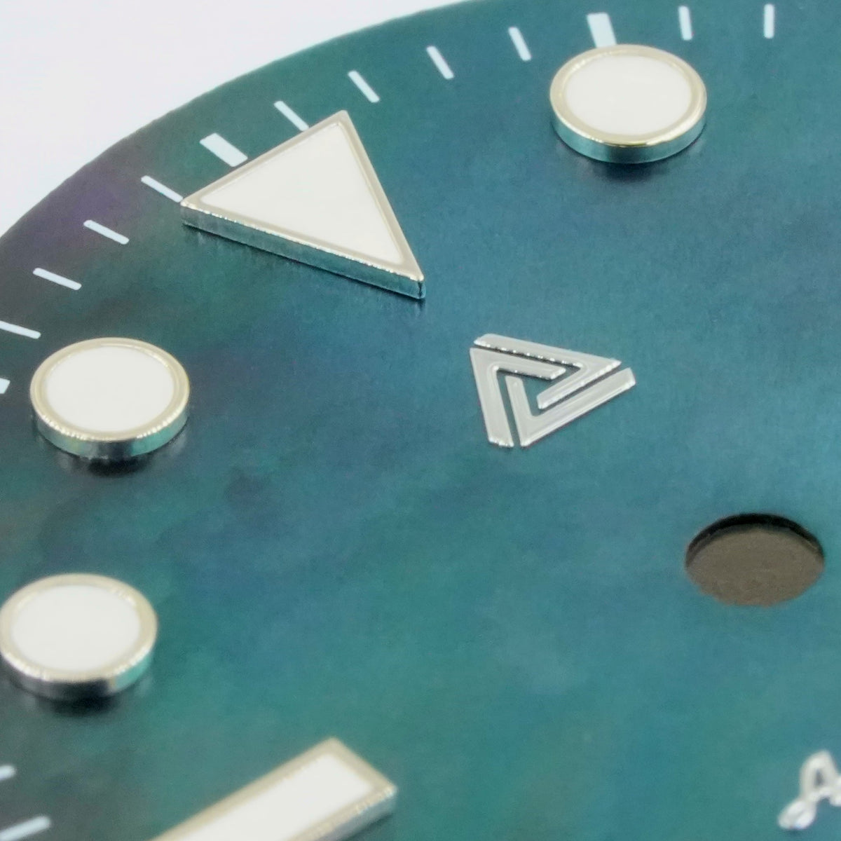 Macro of the black mother of pearl Submariner II date dial — bevelled applied silver indices, printed white minute track and the 3 o'clock date aperture