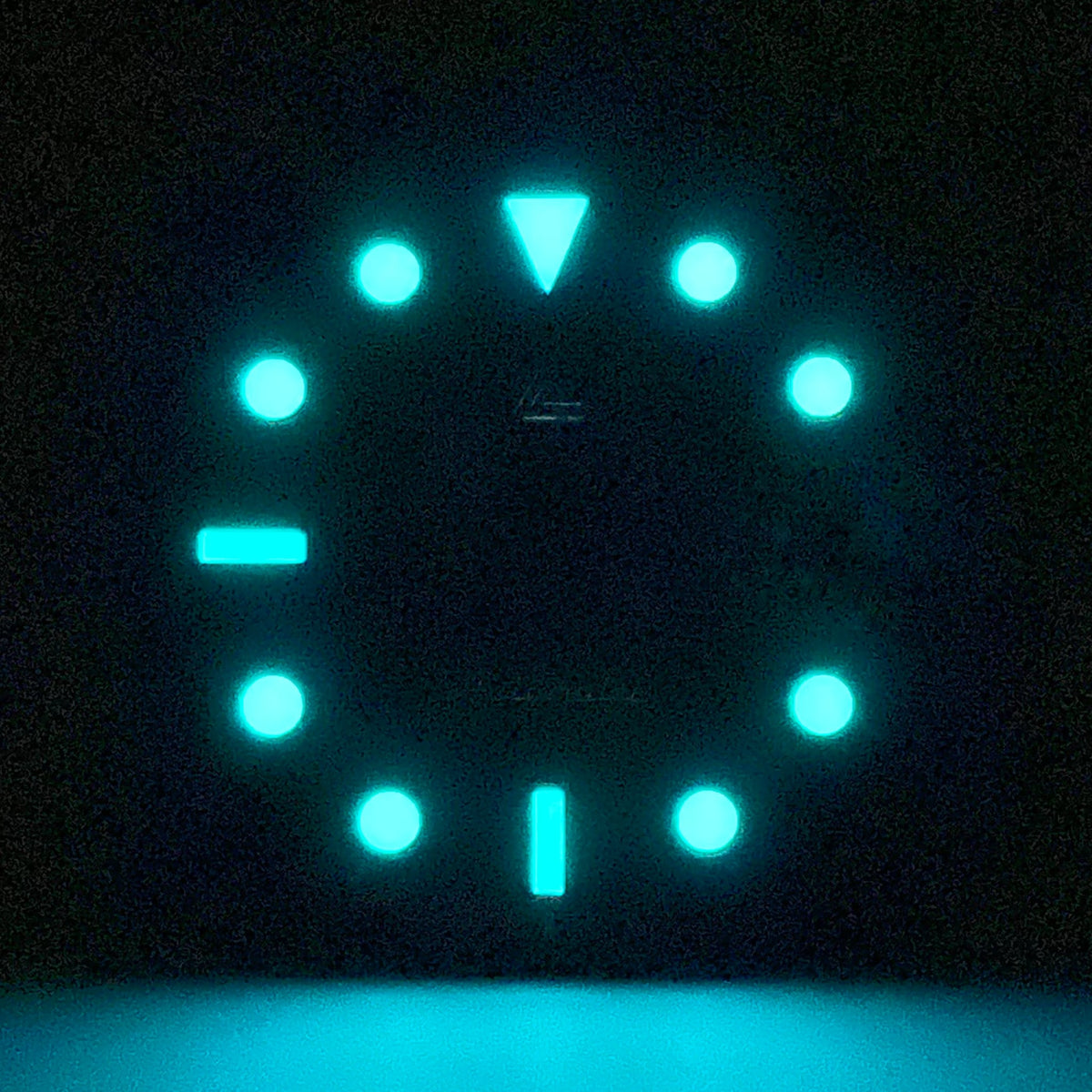 Lume shot of the date glossy black enamel Submariner II dial — BGW9 A-Grade lume glowing cool blue around the 3 o'clock date window
